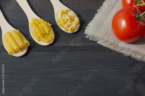 Uncooked pasta in a wooden spoon