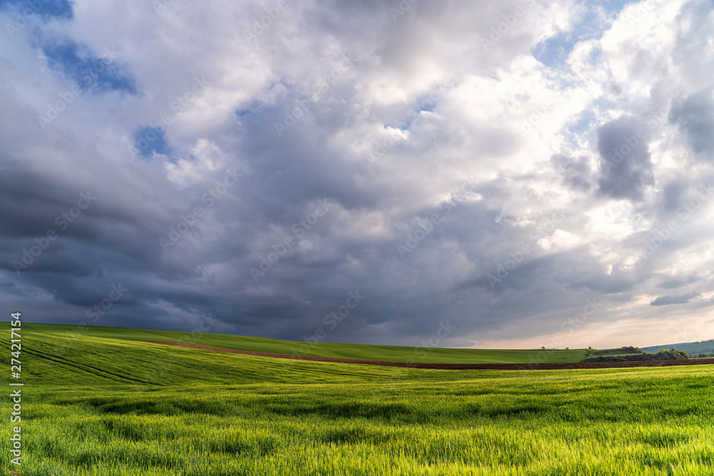 Scenic view of beautiful country landscape. Clouds passing above rural fields in South Moravia, Czech Republic.