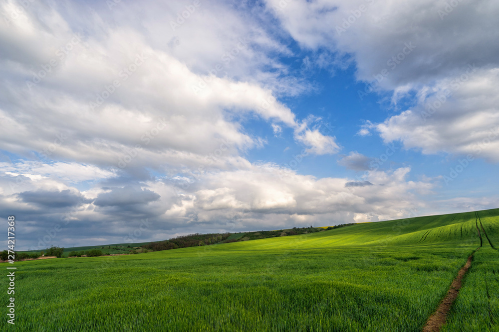 Scenic view of beautiful country landscape. Clouds passing above rural fields in South Moravia, Czech Republic.