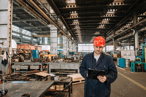 Man working in large metal industry workshop.