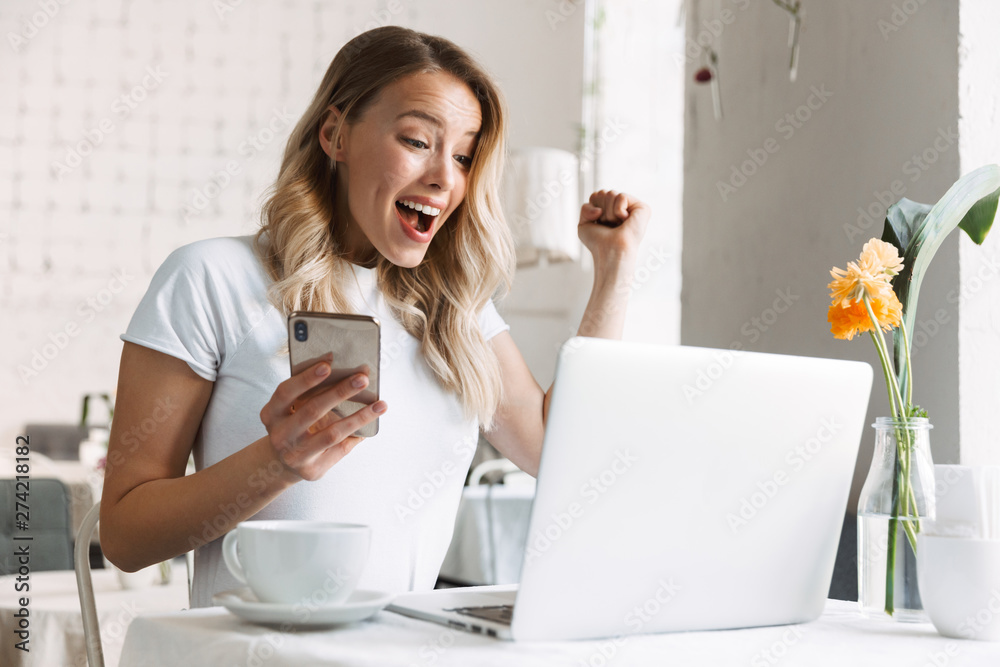 Beautiful young blonde woman sitting at the cafe Beautiful young blonde woman sitting at the cafe