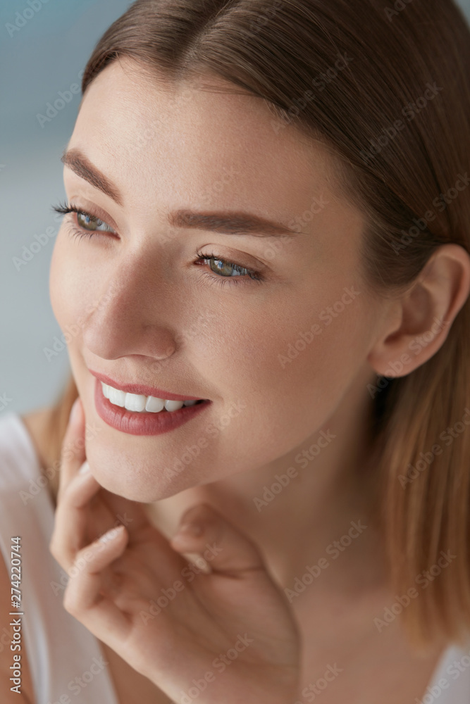 Smiling woman with beauty face and white teeth smile closeup Smiling woman with beauty face and white teeth smile closeup