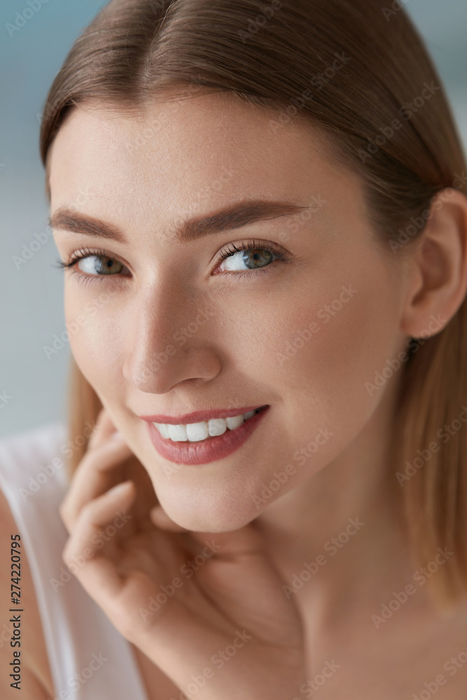 Smiling woman with beauty face and white teeth smile closeup Smiling woman with beauty face and white teeth smile closeup