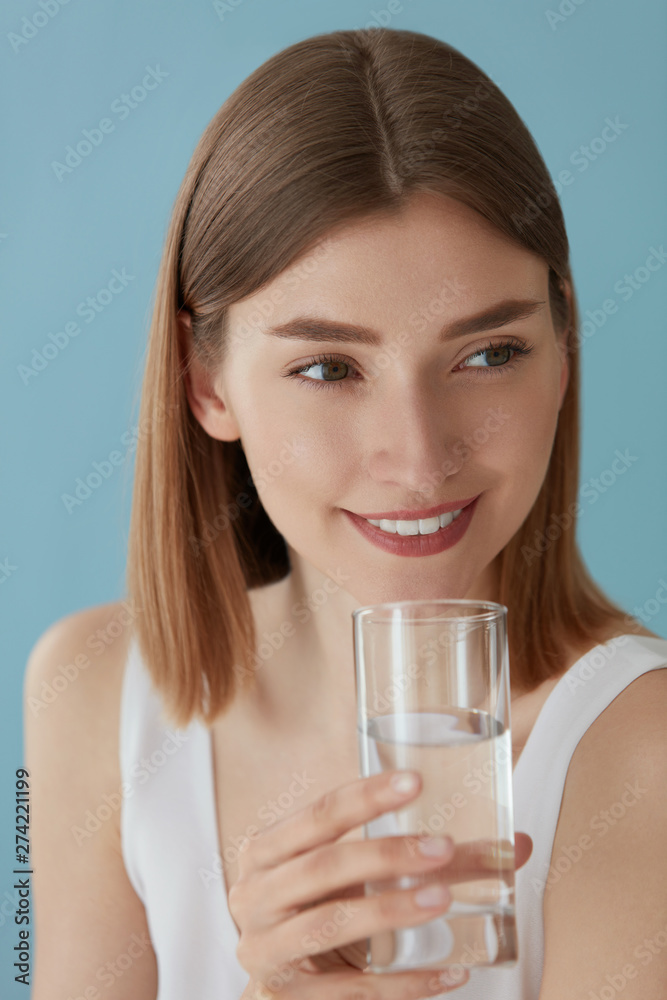 Smiling woman with glass of water indoors portrait Smiling woman with glass of water indoors portrait