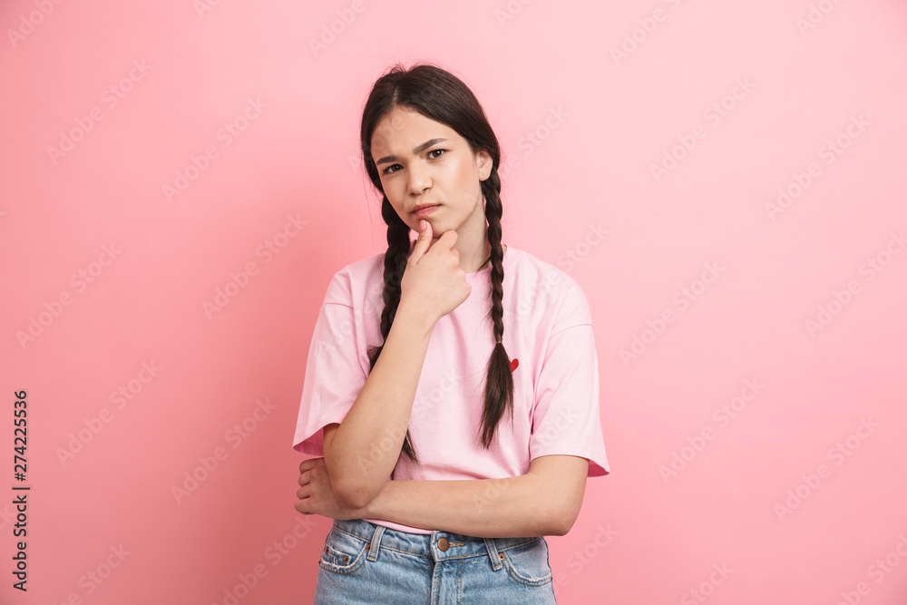 Image of european attractive girl with two braids smiling and looking at camera Image of european attractive girl with two braids smiling and looking at camera