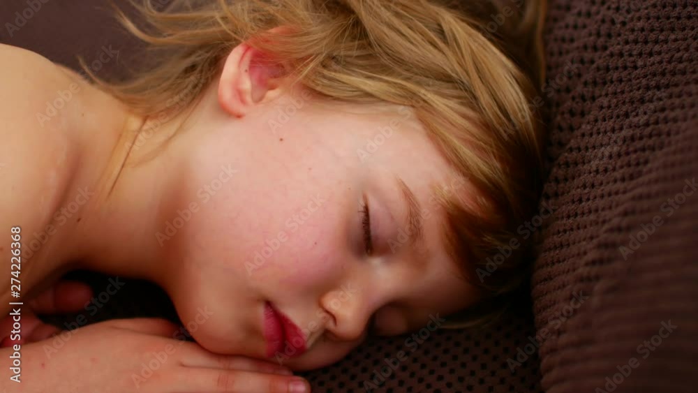 Restless sleep of a child. The girl is spinning in a dream Restless sleep of a child. The girl is spinning in a dream