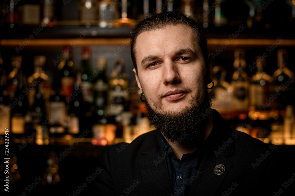 Portrait of young male bartender in bar