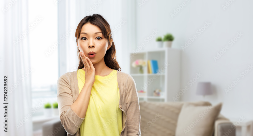 emotion, expression and people concept - surprised asian woman over home room background