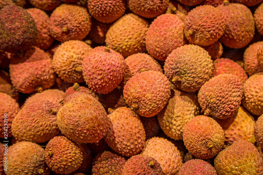 An abundance of lychees for sale on a market stall An abundance of lychees for sale on a market stall