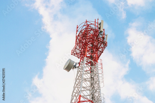 Wireless Communication Antenna Transmitter. Telecommunication tower with antennas on blue sky background.