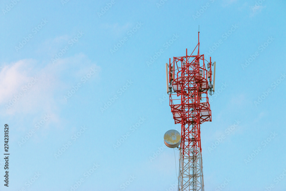 Wireless Communication Antenna Transmitter. Telecommunication tower with antennas on blue sky background. Wireless Communication Antenna Transmitter. Telecommunication tower with antennas on blue sky background.