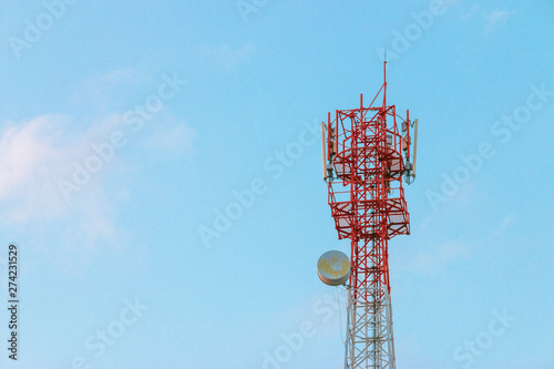 Wireless Communication Antenna Transmitter. Telecommunication tower with antennas on blue sky background.