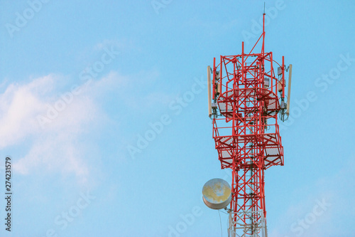 Wireless Communication Antenna Transmitter. Telecommunication tower with antennas on blue sky background.