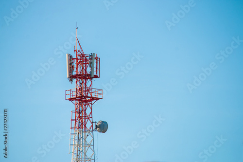 Wireless Communication Antenna Transmitter. Telecommunication tower with antennas on blue sky background.
