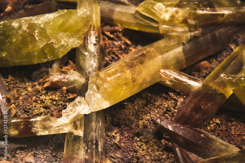 Yellow and brown quartz crystal shards embedded in mineral rock photo