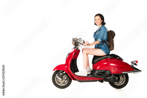 full length view of girl sitting on red scooter isolated on white