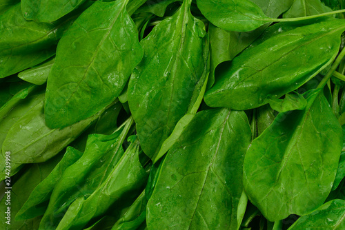Fresh spinach leaves as background.