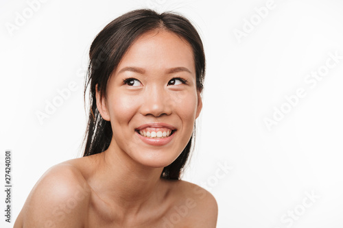 Excited young beautiful asian woman posing isolated over white wall background.