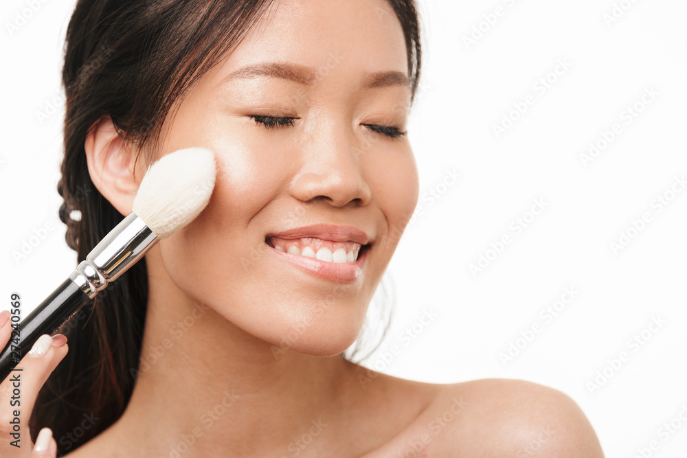 Excited young beautiful asian woman posing isolated over white wall background. Excited young beautiful asian woman posing isolated over white wall background.