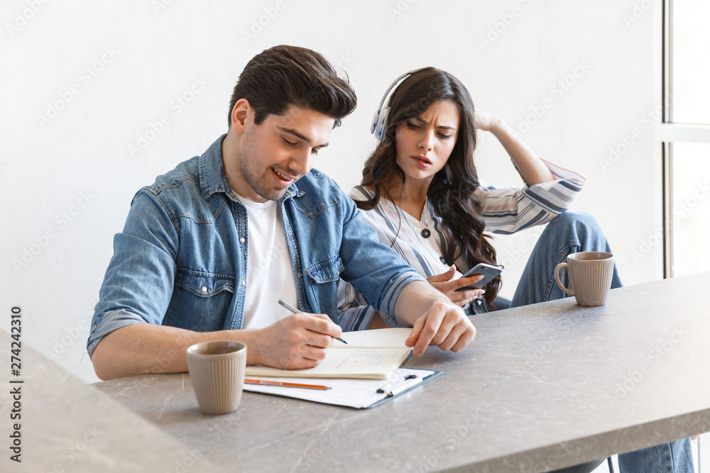 Attractive young couple drinking coffee