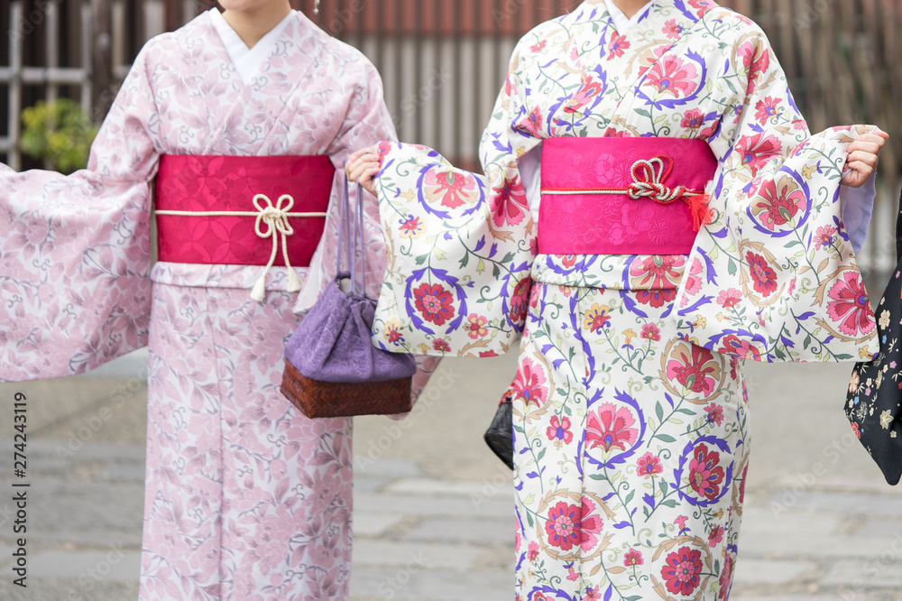 Young girl wearing Japanese kimono standing in front of Sensoji Temple in Tokyo, Japan. Kimono is a Japanese traditional garment. The word Young girl wearing Japanese kimono standing in front of Sensoji Temple in Tokyo, Japan. Kimono is a Japanese traditional garment. The word