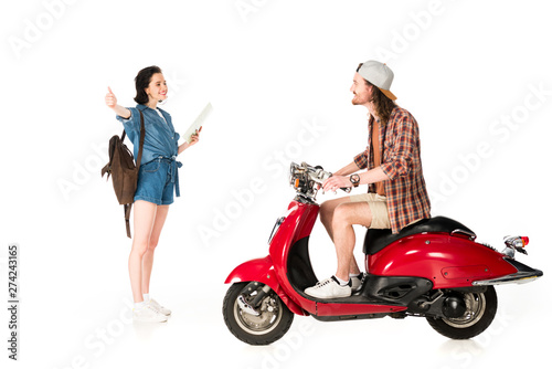side view of young man on red scooter and girl outstretched hand with thumb up isolated on white