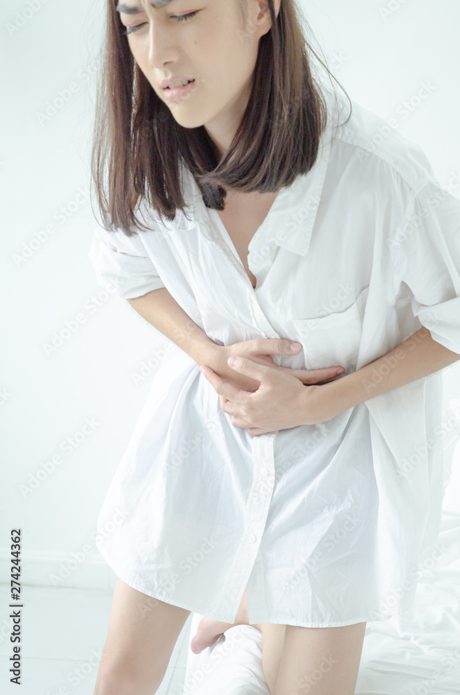 Asian girl has abdominal pain.When is menstruation.Catch his stomach.Women have bladder pain.Do not focus on objects Asian girl has abdominal pain.When is menstruation.Catch his stomach.Women have bladder pain.Do not focus on objects