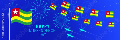 April 27 Togo Independence Day greeting card. Celebration background with fireworks, flags, flagpole and text.