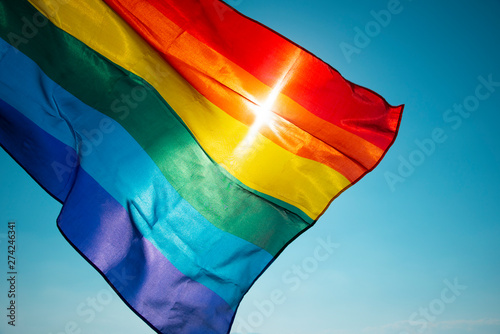 rainbow flag waving on the blue sky