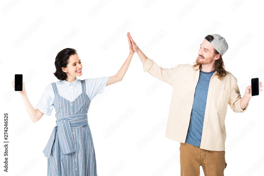 two people holding smartphones in hands and giving high five isolated on white two people holding smartphones in hands and giving high five isolated on white