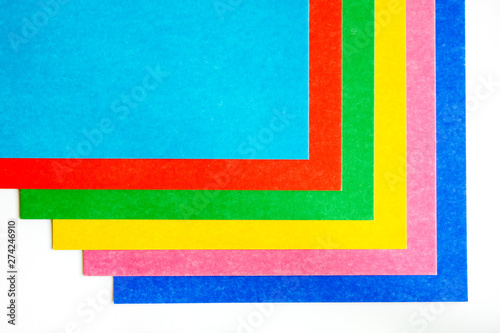 graphic pattern from colorful sheets of cardboard on a white background. Copy space, top view