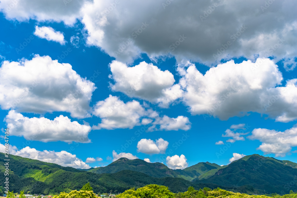Mountain and clouds blue sky background.