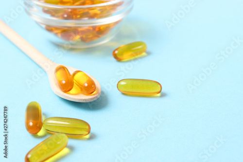 Omega-3 capsules on a colored background. Fish oil, healthy supplements