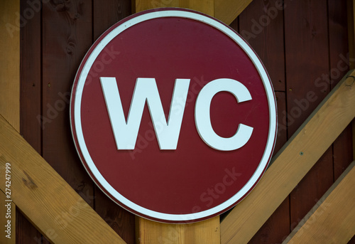 Red wooden toilet sign. WC sign.