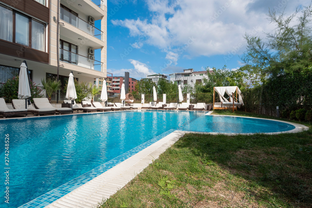 Summer vacation. Swimming pool of luxury hotel with umbrella and chair around. Hotel resort in Bulgaria, Primorsko for travel