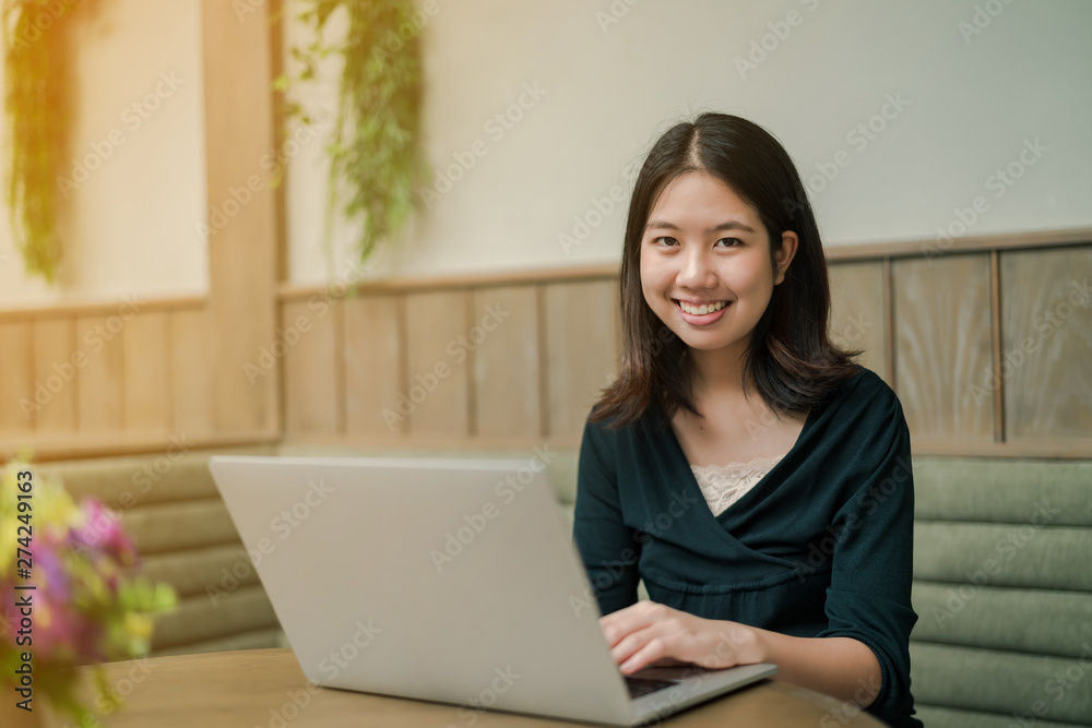 Closeup Asian beautiful woman Wearing a black shirt Sitting in the house Use a laptop computer to work happily. Closeup Asian beautiful woman Wearing a black shirt Sitting in the house Use a laptop computer to work happily.