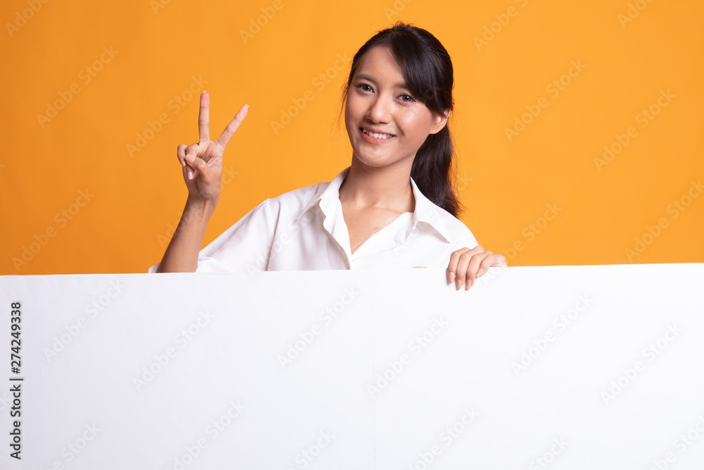 Young Asian woman show victory sign with blank sign. Young Asian woman show victory sign with blank sign.