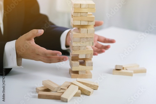 .Planning risk and strategy in businessman gambling placing wooden block.Business concept for growth success proces