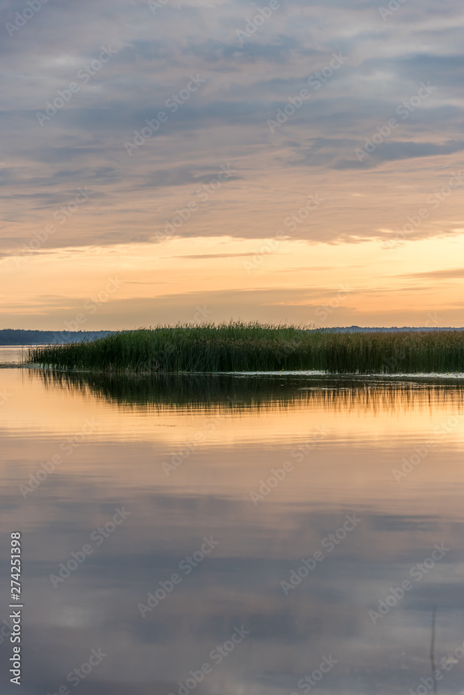 A Still Lake in Rural Latvia at Sunset