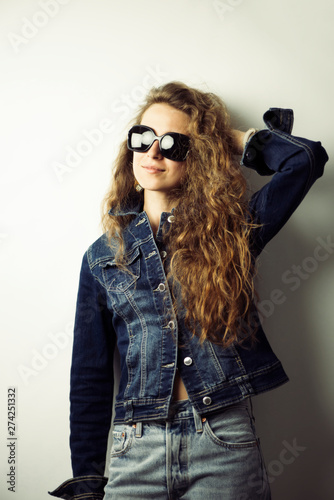 stylish pretty curly girl in a denim jacket © mikitiger