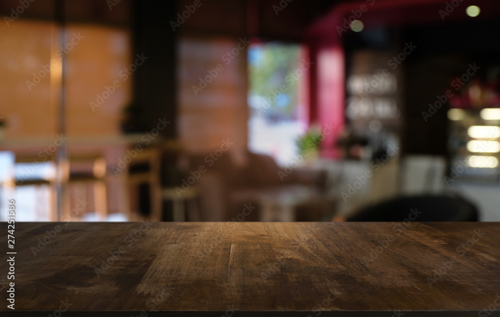 Empty dark wooden table in front of abstract blurred bokeh background of restaurant . can be used for display or montage your products.Mock up for space.