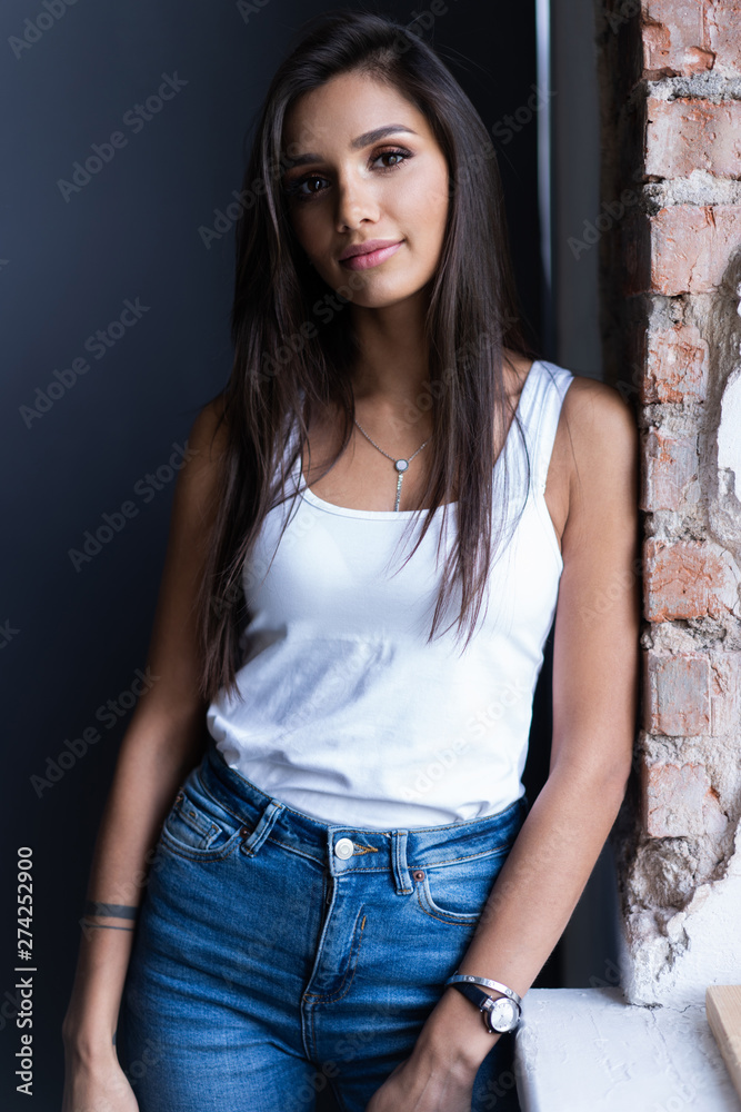 Fototapeta premium Portrait of young beautiful cute cheerful girl smiling looking at camera over gray background.