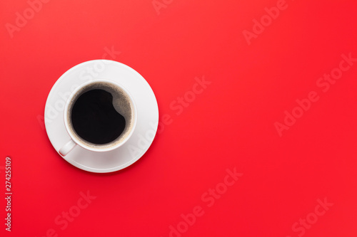 Coffee cup over red background