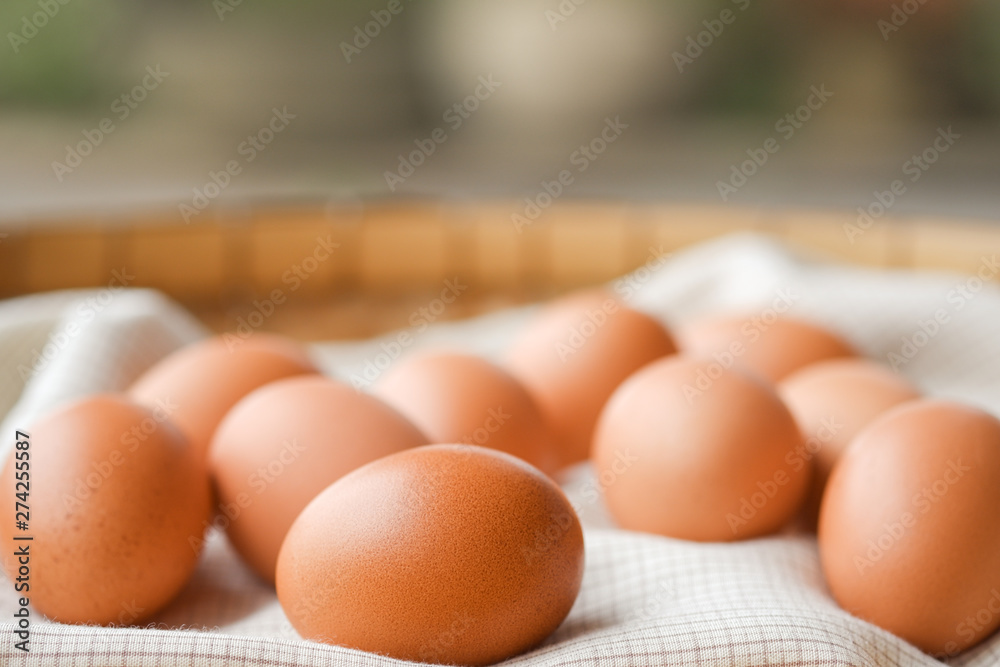 Close-up brown eggs lay on a plaid fabric. Healthy food concepts. Close-up brown eggs lay on a plaid fabric. Healthy food concepts.