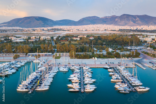 three rows of piers with yachts with view to mountains in Greece