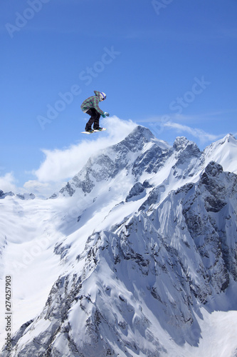 Flying snowboarder on mountains, extreme sport