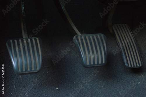 three manual car pedals: clutch, brake and accelerator