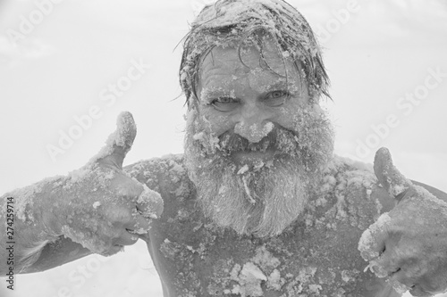 Bearded man, after bathing in the snow
