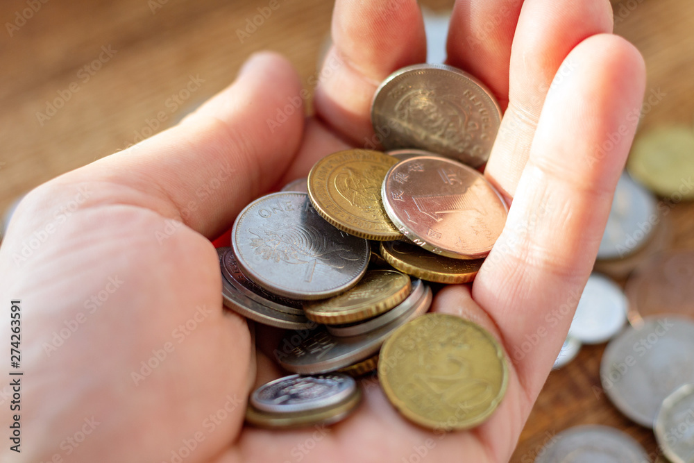 Hand holding full of coins palm payment donation concept economy finance Hand holding full of coins palm payment donation concept economy finance