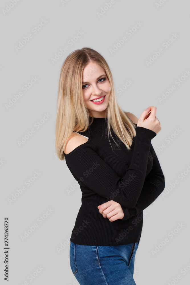 A portrait of a blond girl smiling. Background is light gray. A portrait of a blond girl smiling. Background is light gray.